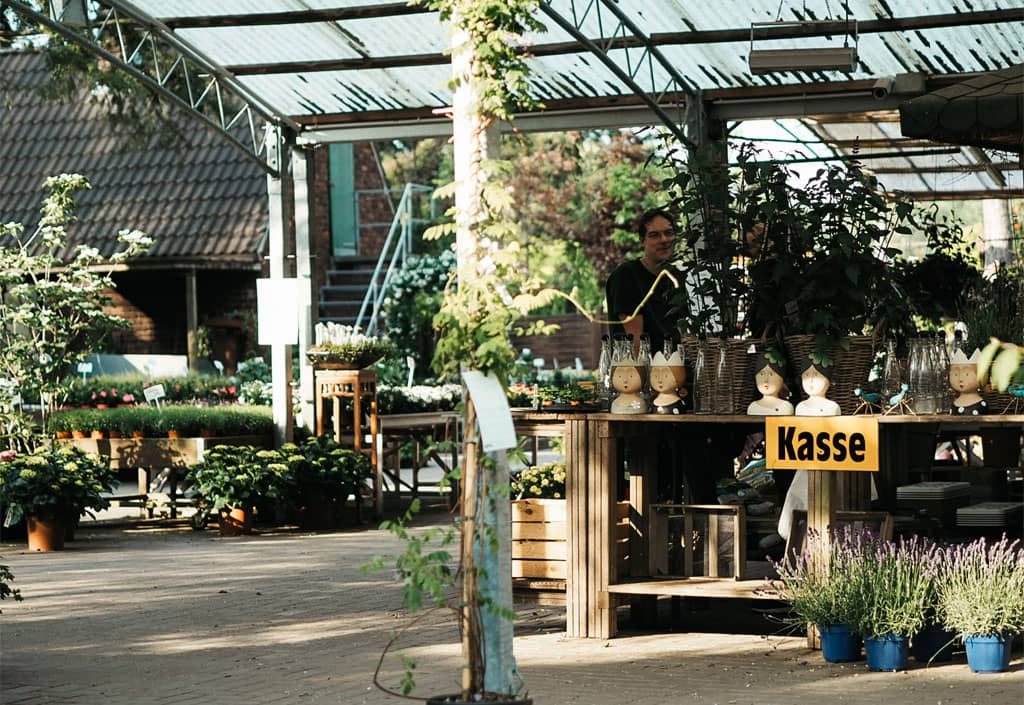 Inhaber Christian Sill hinter dem Kassenbereich im Pflanzgarten